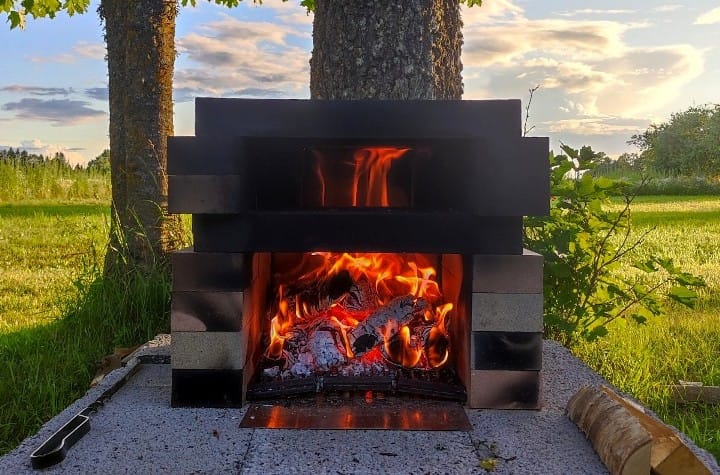 Fire roaring inside the DIY brick pizza oven