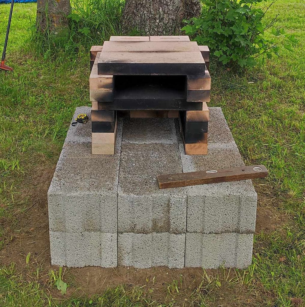Outdoor pizza oven base built from 12 large construction blocks
