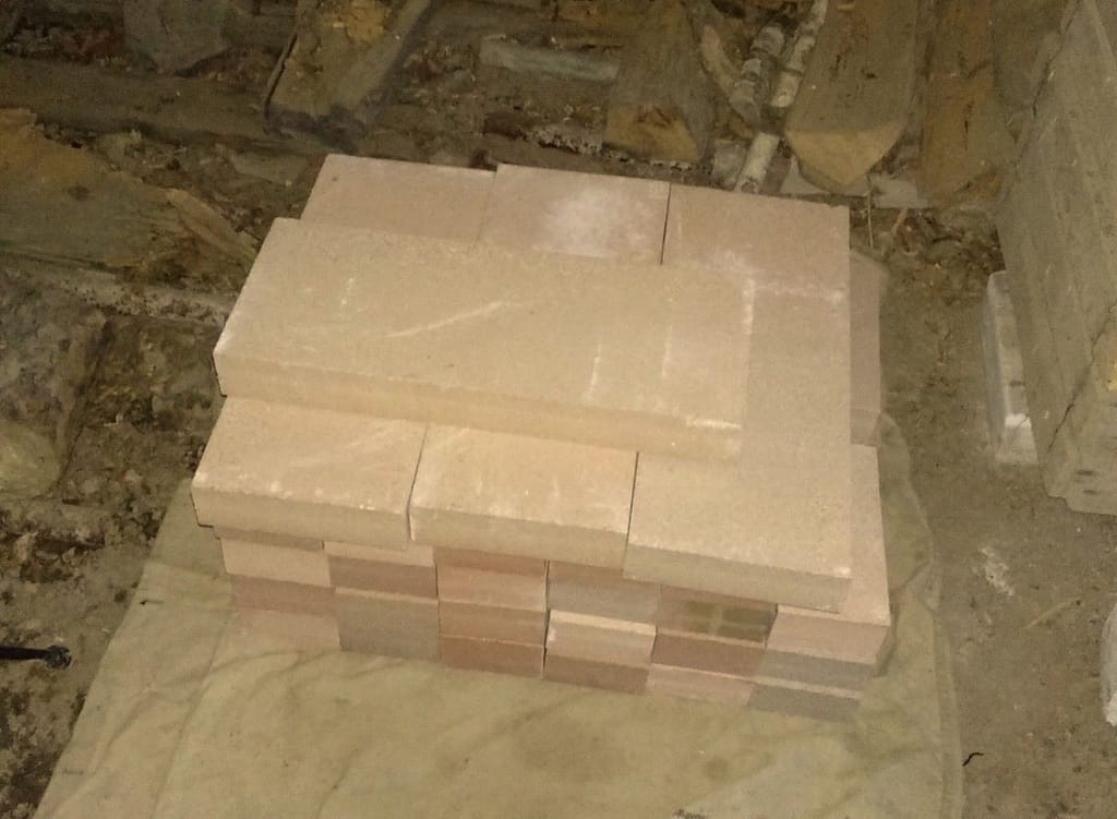 A pile of firebricks and slabs for building the easy DIY outdoor pizza oven